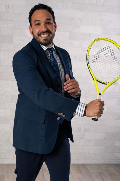 Dr. Jeff Abettan holding a tennis racket