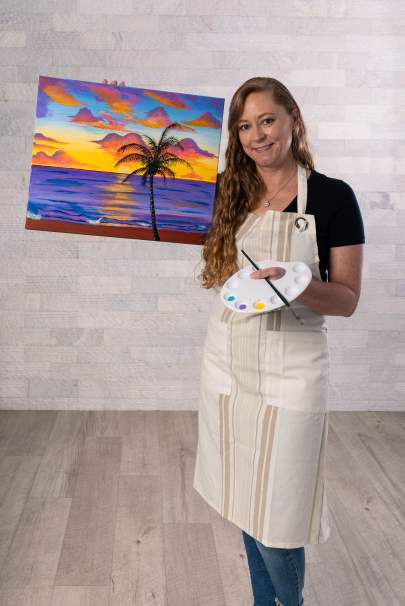 Rebekah Jaffe in a painter's apron and color palette